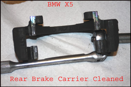 BMW X5 - Rear brake caliper removed for cleaning.