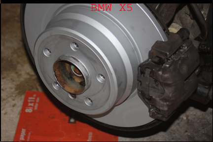 BMW X5 - Shows complete rear brake pad installation.