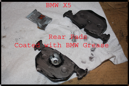 BMW X5 - New rear brake pads with BMW brake grease on them.