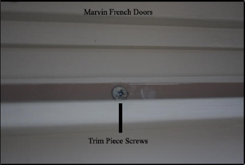 Marvin wood French doors - Shows screw holding trim piece that must be removed to remove trim