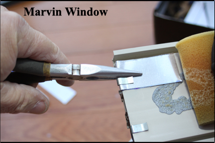 Marvin Wood Double Hung Windows - Shows Aluminum Strip Being Crimped Down Over Vinyl Track Edge