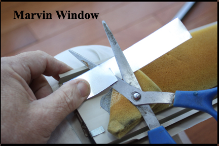 Marvin Wood Double Hung Windows - Shows Aluminum Strip Placed Over Broken Vinyl Track Being Cut off On the Back Side