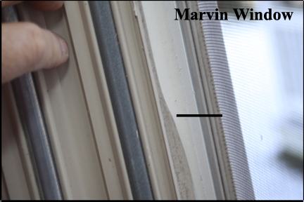 Marvin Wood Double Hung Windows - Shows inserting soft edge of vinyl track into window frame