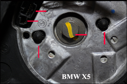 BMW X5 - Steering Wheel Removal Showing How Yellow Marker needs to line up as plastic prongs on black ring on sterring column.