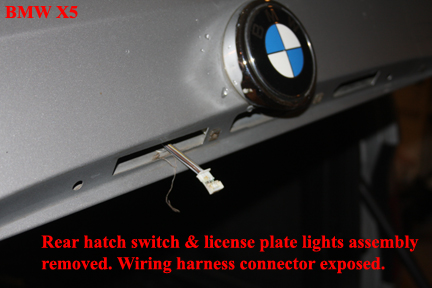BMW X5 - Replacing the Rear Upper Hatch Switch - Wiring harness exposed.