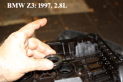 BMW Z3: Shows Removing Old Gasket Around Coil Holes.