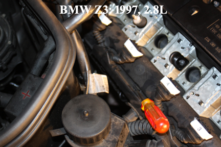 BMW Z3: Shows Prying Loose Coil Cable Box From Valve Cover.
