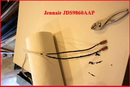 Jennair JDS9860AAP showing spark wires coated with liquid electrical tape