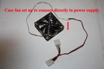 Shows personal computer (PC) case fan with power adapter to allow direct power supply connection